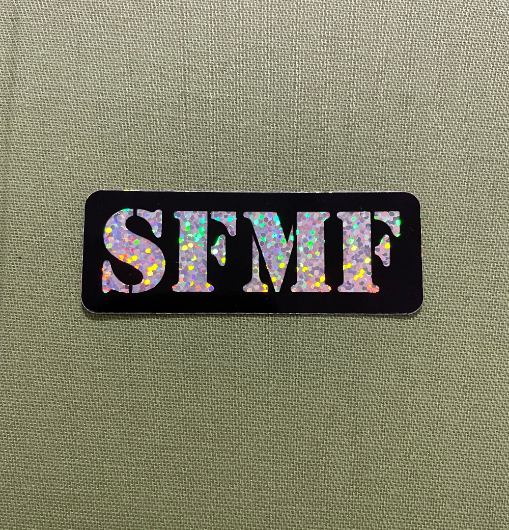 Sticker with 'SFMF' in shiny letters on a black background