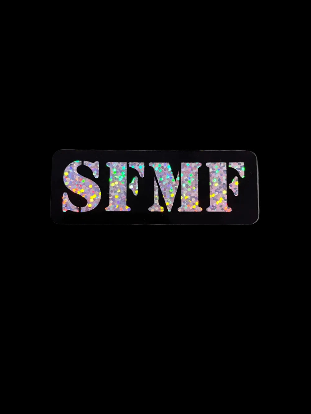 A rectangular sticker with black border featuring the text 'SFMF' in glittery multicolor letters.